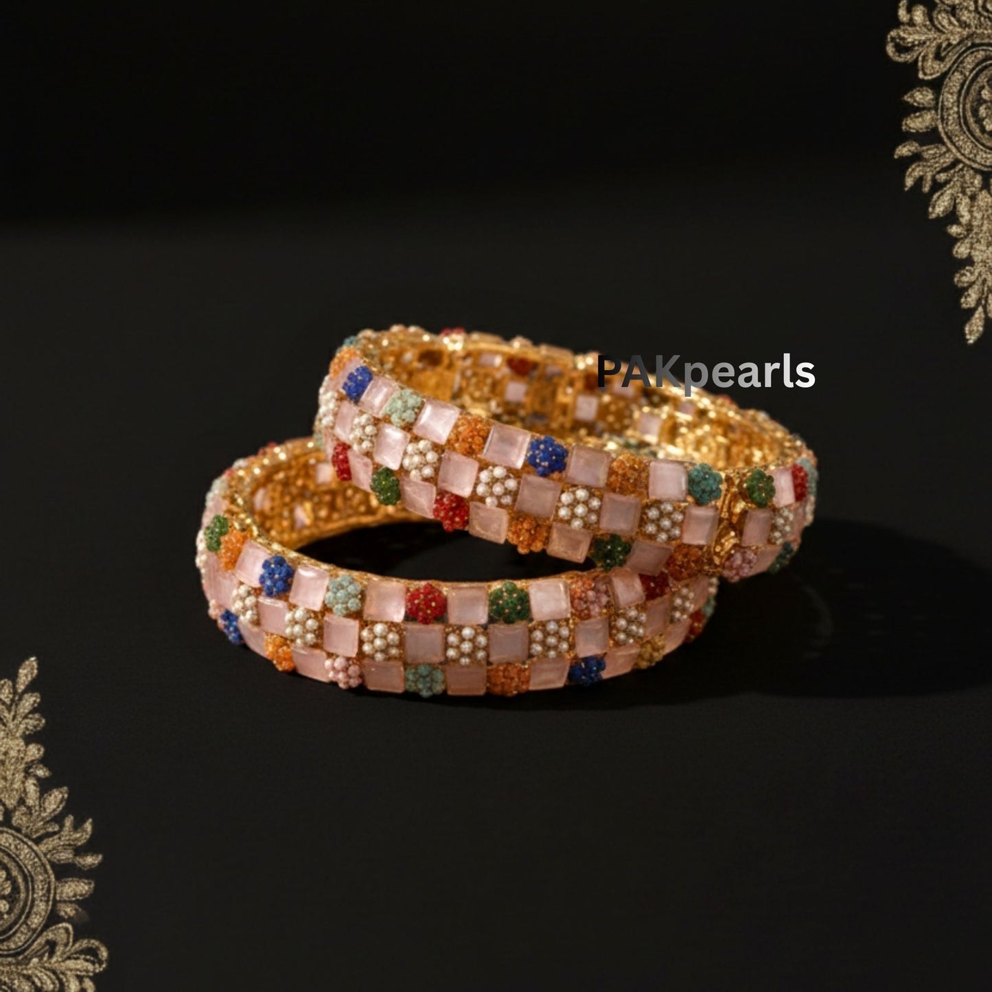 Pair of baby pink Mona Lisa stone bangles featuring multicolored floral bead clusters on a gold-plated base