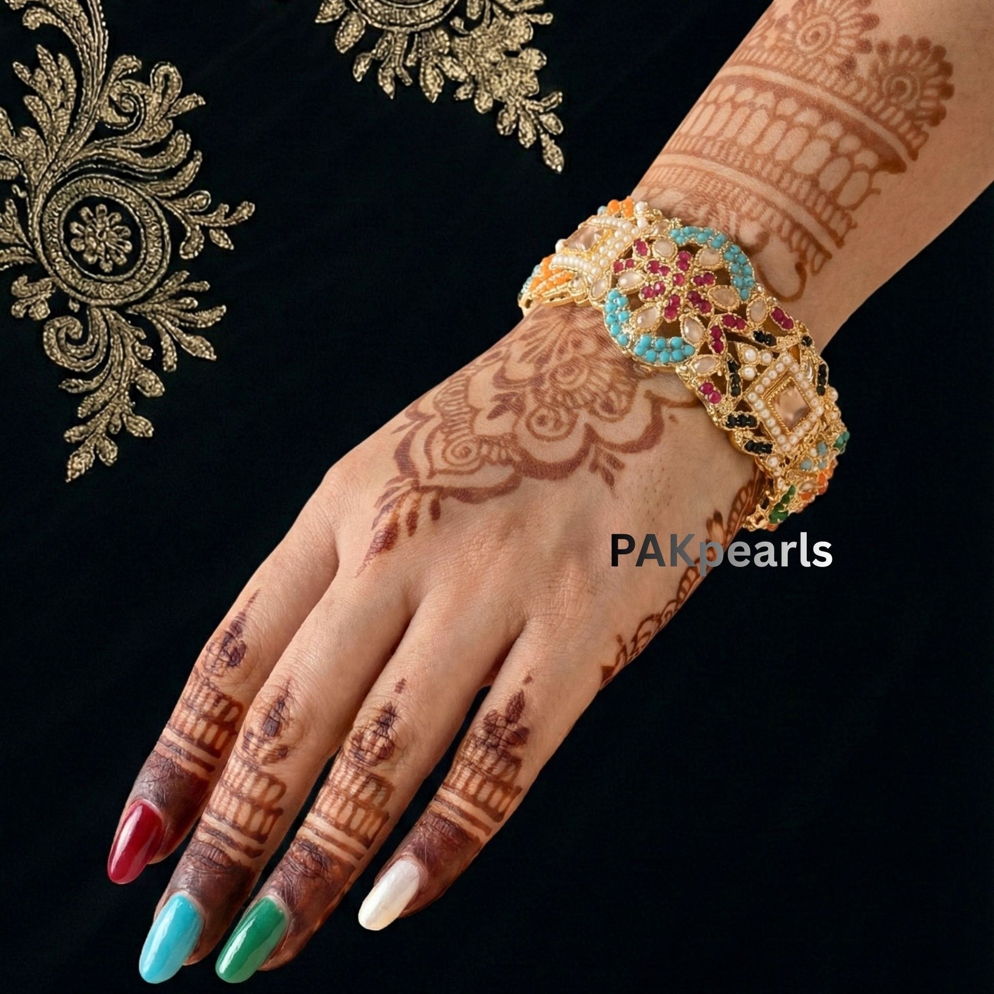 Hand wearing heavy gold Nauratan bangles from PAKpearls, 