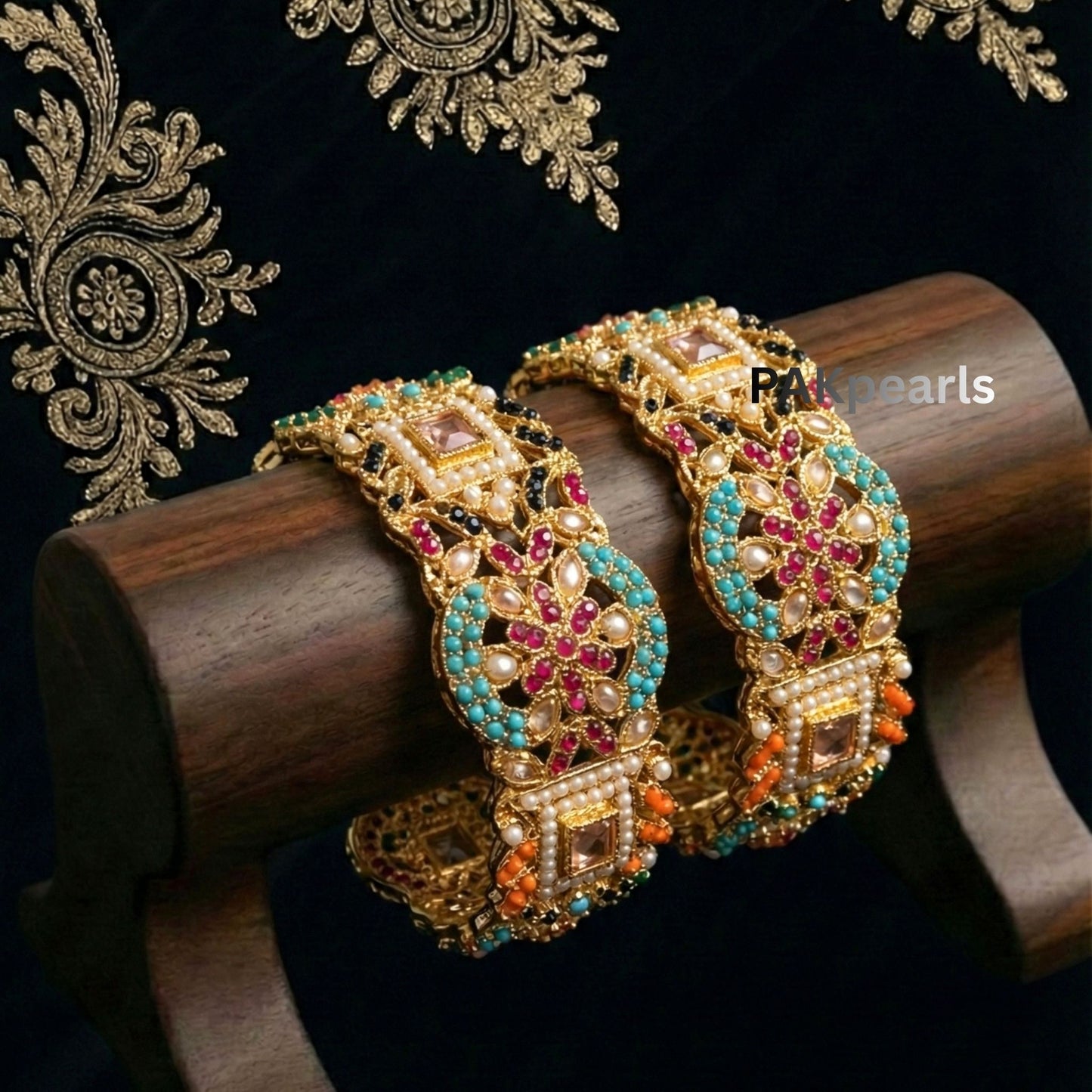 Nauratan style gold bangles with a rich arrangement of colorful gemstones and seed pearls, showing the clasp detail.
