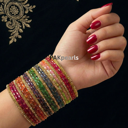 Multi-color Indian Raindrop glass bangle set of 26 pieces featuring vibrant faceted glass and gold-toned stone-encrusted borders by PAKpearls.